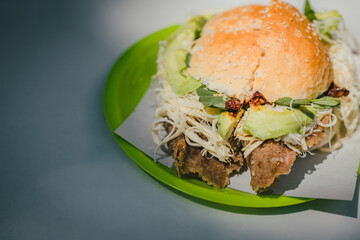 Traditional cemita from Puebla, a dish made up of bread with sesame seeds, cheese, avocado, onion and chicken or pork milanese.