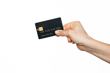 A female hand holding a black plastic credit card with blank for text or design isolated on a white background. Shopping, payment for purchases, banking operations. Mockup with empty copy space