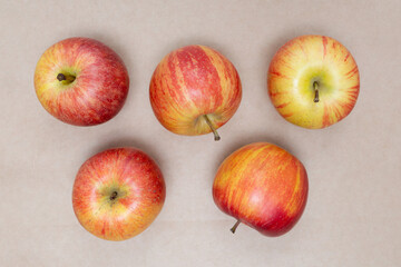 Red apples on brown craft paper. Flat lay. Top view.