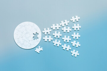 Close up Businesspeople hand holding jigsaw puzzle on blue background, success and strategy concept.