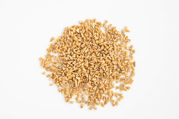 Handful of crushed whole wheat grain on a white background,top view