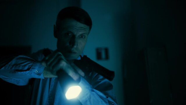 Detective holding a gun in dark building, police operation, exploring place