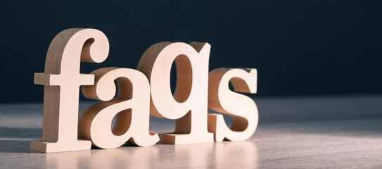 FAQs (Frequently Asked Questions) wood word in spot light