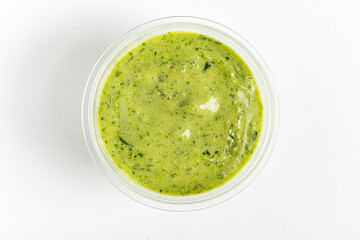 green sauce dip on white