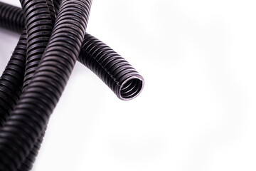 on a white background. black corrugated tube for laying cable in the car