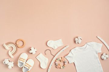 Mockup of white infant bodysuit made of organic cotton with eco friendly baby accessories. Onesie...