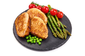 Grilled pork steaks with asparagus, isolated on white background. High resolution image.