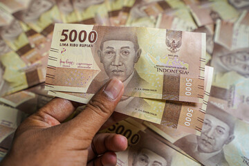 Money background. Cash money with the amount of five thousand rupiah "Rp5.000". The official currency of Indonesia from Bank Indonesia. 