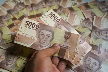 Money background. Cash money with the amount of five thousand rupiah "Rp5.000". The official currency of Indonesia from Bank Indonesia. 