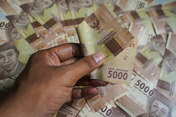 Money background. Cash money with the amount of five thousand rupiah "Rp5.000". The official currency of Indonesia from Bank Indonesia. 