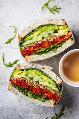 Gordijnen Vegetable sandwich in paper wrap. Vegan healthy food, takeaway food. © vaaseenaa