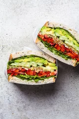 Zelfklevend Fotobehang Vegetable sandwich in paper wrap. Vegan healthy food, takeaway food. © vaaseenaa
