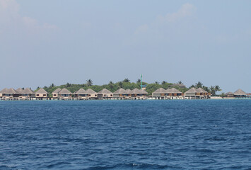Fototapeta na wymiar Maldives. Indian Ocean. Bungalow hotel on the water.