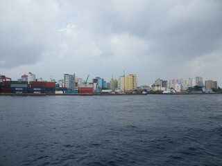 Maldives. Male. Capital of the Maldives. Cloudy sky and blue ocean.