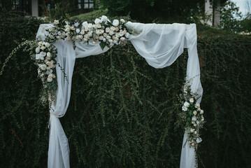Wedding arch made of fresh flowers for the ceremony.