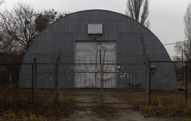 Fototapeta na wymiar Gray hangar. The door to the hangar