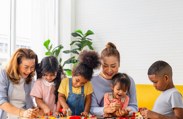 Grandparents and grandchildren playing in living room, Grandma spending happy time with little kid girls and boy