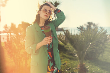 Woman outdoors holding a bamboo coffee mug to go