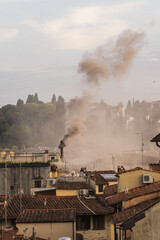 smoke from the chimney and old roofs in Florence, Italy 