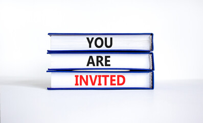 You are invited symbol. Concept words You are invited on books. Beautiful white table white background. Business and you are invited concept. Copy space.