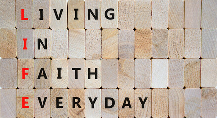 LIFE living in faith everyday symbol. Concept words LIFE living in faith everyday on wooden blocks on beautiful wooden background. Business LIFE living in faith everyday concept. Copy space. - obrazy, fototapety, plakaty