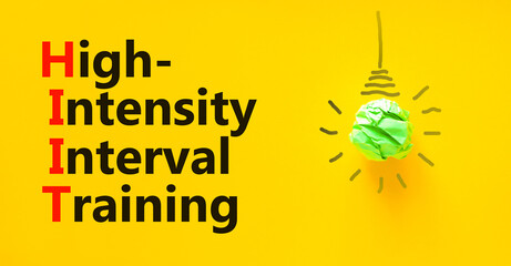 HIIT high-intensity interval training symbol. Concept words HIIT high-intensity interval training on a beautiful yellow background. HIIT high-intensity interval training concept. Copy space.
