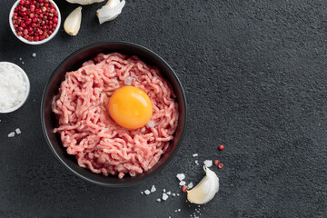 Cutlet ingredients beef farce meat with egg in a plate