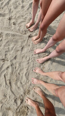 seen from above ten feet on the sandy beach of a five person family