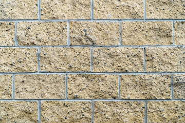 Finishing the foundation of the house with a decorative stone from a broken beige color.