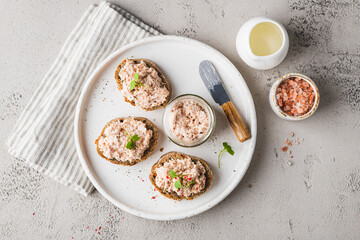 bruschetta with tuna pate, fish rillettes, sandwich on a white plate, top view