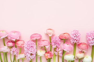 Pink ranunculus and hyacinths on a pink background. Mothers Day, Valentines Day, birthday concept - obrazy, fototapety, plakaty