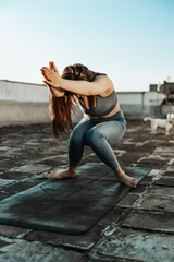 Woman Doing Yoga Outdoors On A Rooftop Terrace