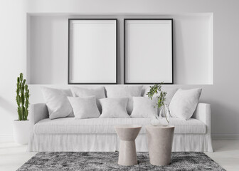 Two empty vertical picture frames on white wall in modern living room. Mock up interior in contemporary, scandinavian style. Free space for picture, poster. Sofa, table, carpet, plants. 3D rendering.