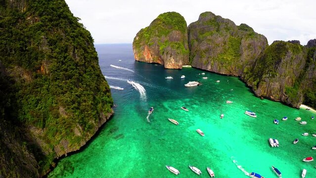 Aerial Shot Of Nautical Vessels In Turquoise Sea, Drone Flying Backwards Over People At Beach On Vacation - Bangkok, Thailand