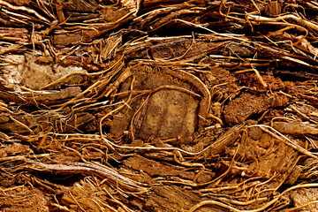 Compressed bale of ground coconut shell fibers coir, surface background.