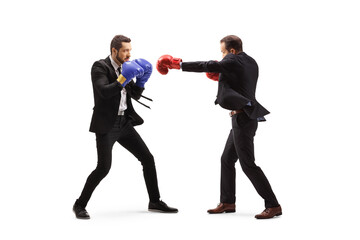 Full length profile shot of two businessmen fighting with boxing gloves