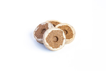 Peat briquettes for growing seedlings and young plants on white background