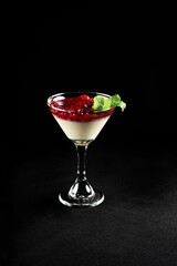 red fruit dessert, raspberry sauce, strawberry with cream and jam served in a glass bowl