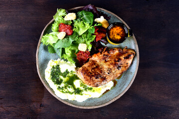 plate with piece of meat roasted chicken with bacon vegetable salad and mustard sauce