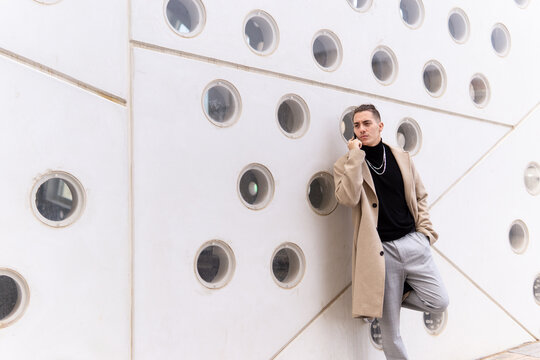 Portrait of a young mixed-race man talking on a smartphone in the city. Social media, communication, mobile apps, business, lifestyle concept