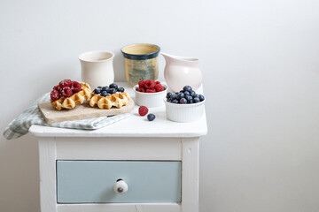 Served breakfast of waffles and summer berries.