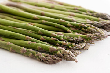 Green asparagus, on a towel on a white background.