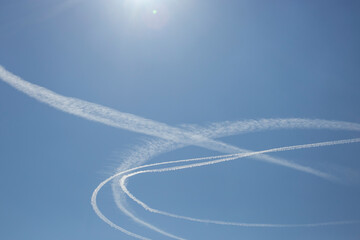circular condensation trail made from aerial patrol jets