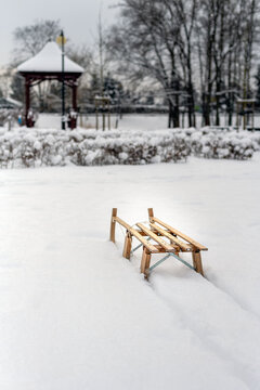 Wooden Sledge in the snow in the city park in winter, Cracow, Poland
