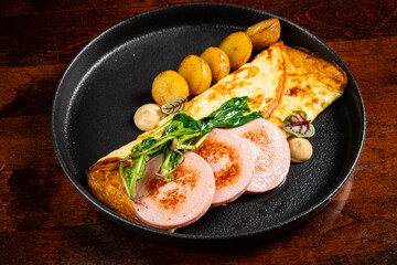 omelet with sausage and baked potato