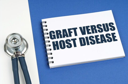 On A Blue-white Surface Lies A Stethoscope And A Notepad With The Inscription - Graft Versus Host Disease