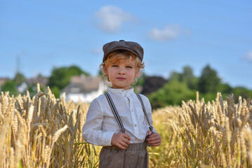 A blond boy in the field