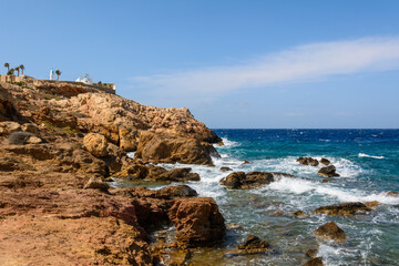 Rocky coast of Koumbara beach located on Ios Island. Cyclades, Greece