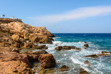 Fototapeta na wymiar Rocky coast of Koumbara beach located on Ios Island. Cyclades, Greece