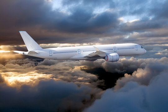 Passenger plane in the sky. Aircraft flying high above the storm clouds. Side view of aircraft.